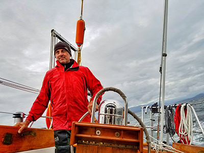 Bert terHart behind the rudder of his sailboat, the ninth person who sailed around the world alone, using only the traditional navigational tools