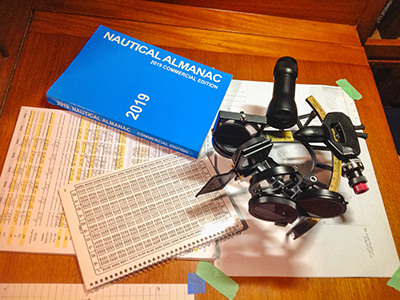 Sextant and nautical charts, the traditional navigational tools Bert terHart used while sailing aroung the world