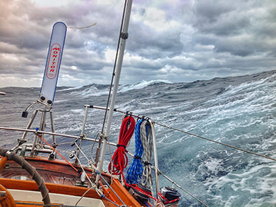 Cloudy skies above and huge waves under Bert terHart's sailboat during his circumnavigation of the globe