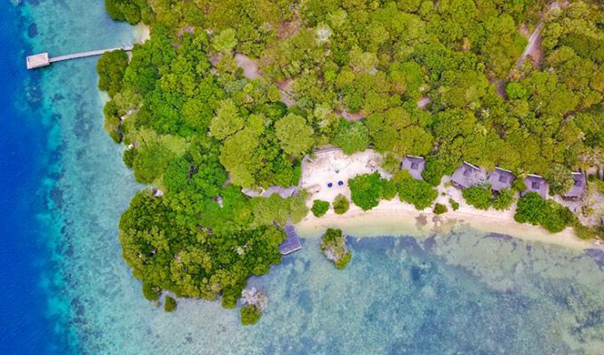 The aerial photo of The Menjangan Resort on Sentigi Beach in Bali, with beach villas and Pantai Restaurant surrounded by mangrove trees, copyright Lifestyle Retreats