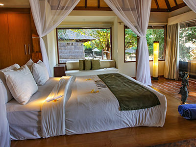 Interior of the Beach Villa at The Menjangan Resort, with large canopy bed and windows, Bali, Indonesia, photo by Ivan Kralj