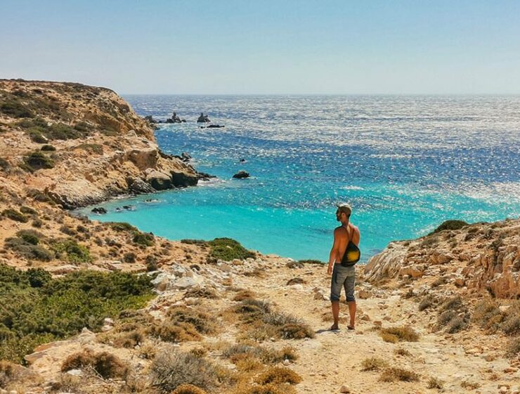 Pipeaway blogger Ivan Kralj standing at the coastline of Donousa, an island in Greece, one of the top 10 countries to discover in 2021 according to international travel predictions 2021, photo by Nikos Samartzis