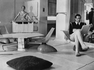 Futuristically dressed man and woman in the House of the Future designed by Alison and Peter Smithson in 1956, exhibited at Vitra Design Museum's exhibition "Home Stories"