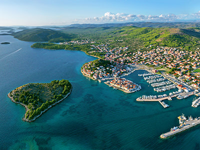 Heart-shaped island of Lukovnik in the Adriatic Sea, Croatia, in front of the village of Tribunj, aerial photo by Boris Kačan