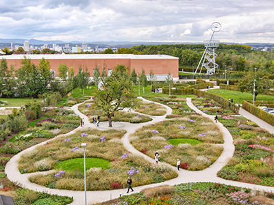 Vitra Factory Building by architect Alvaro Siza is surrounded by a colorful park with flowers and a variety of smaller design expositions, Vitra Campus, Weil am Rhein, Germany, photo by Ivan Kralj