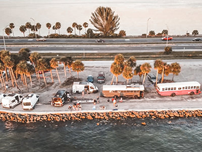 Nomad community meet-up of converted buses and vans by the road in the United States