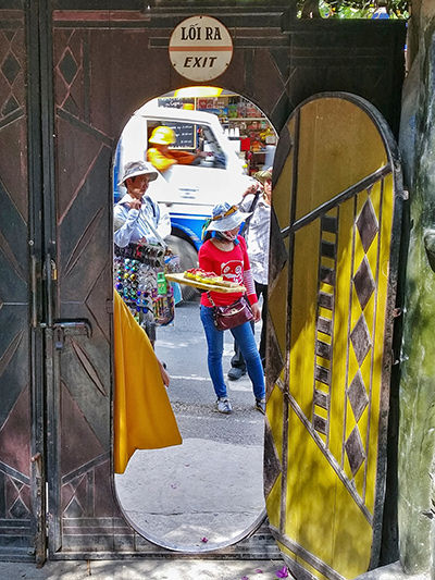 Local vendors trying to sell trinkets to the tourists at the entrance of the Crazy House in Dalat, Vietnam, photo by Ivan Kralj