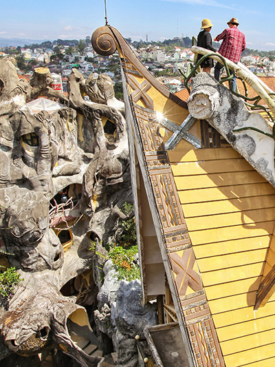 Tourists standing on the rooftop of the oddly-shaped Crazy House in Dalat, Vietnam, photo by Ivan Kralj