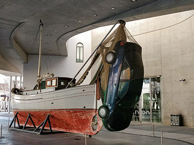 Artwork showing a ship catching a car in a fish net, displayed at MAXXI, the National Museum of 21st Century Art in Rome, Italy, photo by Ivan Kralj