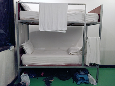 Bunk bed with towels in a hostel in Luang Prabang, Laos, photo by Ivan Kralj