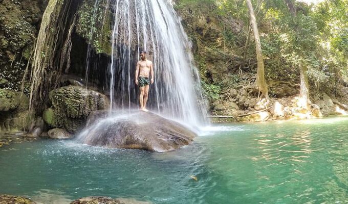 Pipeaway blogger Ivan Kralj standing under a tropical waterfall in Erewan Falls, Thailand, solo travel, photo by Ivan Kralj