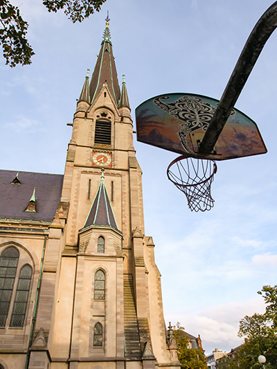 Basketball hoop in front of the Matthauskirche church. Playing sports at unconventional places is one of the best free things to do in Basel, Switzerland. Photo by Ivan Kralj