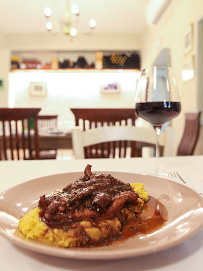 Octopus Stifado, slow-cooked octopus with onion, fresh tomato, orange, and grape molasses, served with fava, in Yemeni Wine Restaurant in Naoussa, Paros, Greece, photo by Ivan Kralj