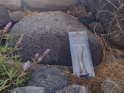 The empty packaging for dildo, a sex toy, on the pathway to Koloumbo Beach, the nude beach of Santorini, Cyclades, Greece, photo by Ivan Kralj