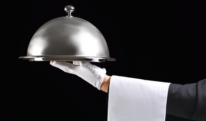Waiter's hand with tray and cloche, waiting tables, photo by Serezniy, Depositphotos
