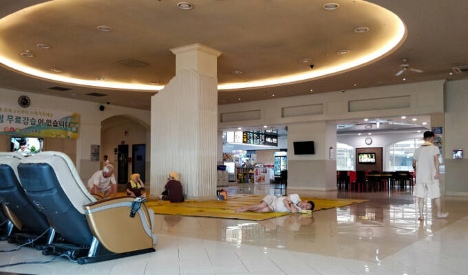 People resting on the floor of The Spa in Garden 5 shopping center, one of the best jjimjilbangs in Seoul, South Korea, photo by Ivan Kralj