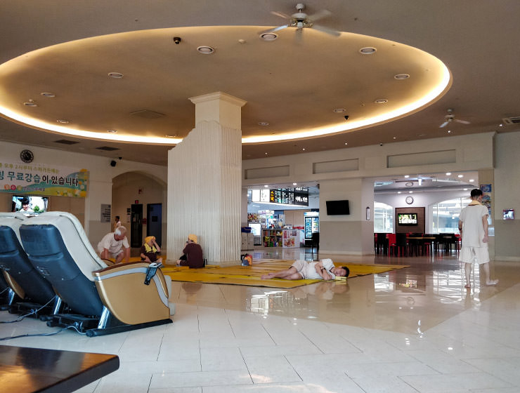 People resting on the floor of The Spa in Garden 5 shopping center, one of the best jjimjilbangs in Seoul, South Korea, photo by Ivan Kralj