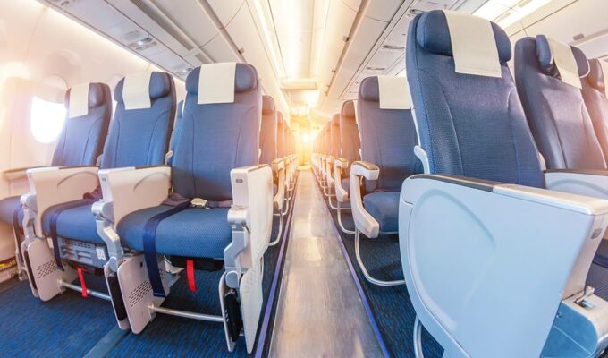 View of the plane aisle with bulkhead seats in the first plan, photo by Aapsky, Depositphotos.com