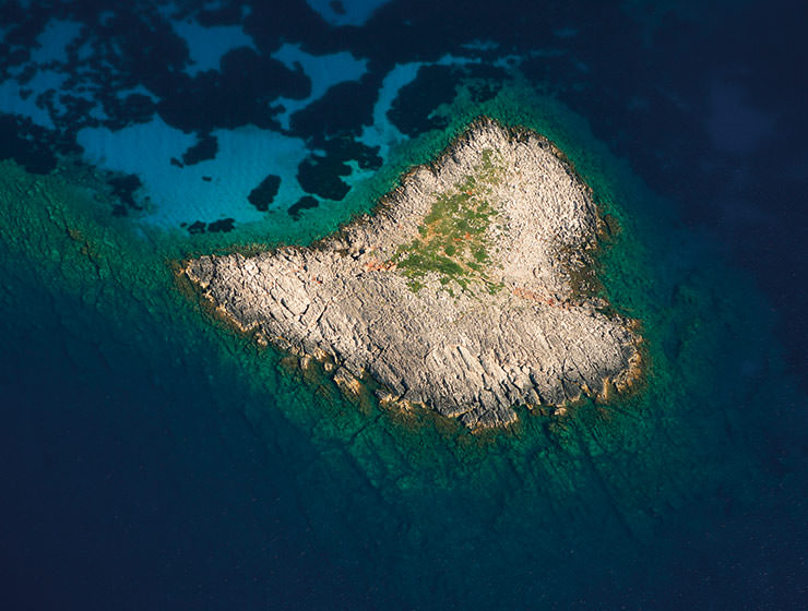Aerial photo of Kardia, a rocky heart island in Greece, photo by Costa Navarino, Creative Commons