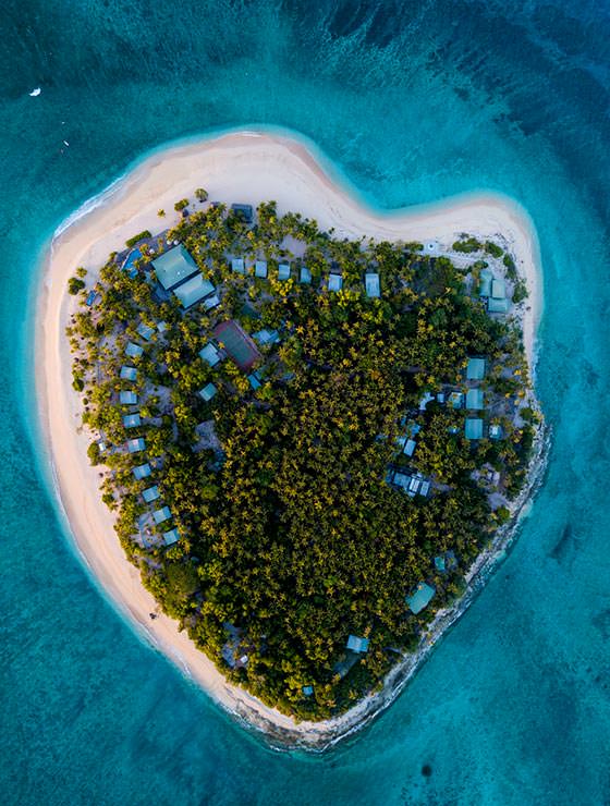 Aerial photo of Tavarua, heart-shaped island in Fiji, photo by Tavarua Resort