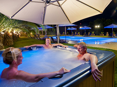 Nudists relaxing in a hot tub at night, at Vassaliki Naturist Resort in Kefalonia, one of the best nudist hotels in Greek islands, photo by Vassaliki