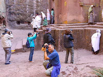 A group of Chinese tourists obsessively photographing churchgoers at Bete Giyorgis in Lalibela, Ethiopia, photo by Ivan Kralj