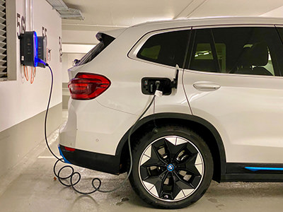 Electric car connected to the EV charging station, photo by Eren Goldman, Unsplash