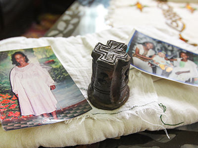 Family photographs of Woldemariam family and miniature Bete Giyorgis church souvenir, on top of the freshly washed netela, all given to Pipeaway blogger Ivan Kralj as a present of gratitude for defending Ethiopians from photography-obsessed Chinese tourists