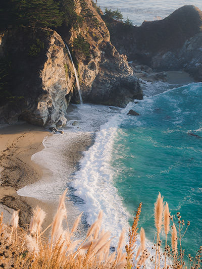 McWay Falls, waterfall dropping directly on the sandy beach in Julia Pfeiffer Burns State Park, California, one of the stops on Big Sur road trip, photo by Braxton Stuntz, Unsplash