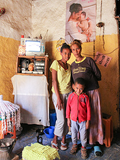 Mame Esayte Woldemariam posing with her children, 11-year-old daughter Tigist and 5-year-old son Ashenafi Sisay in their modest home in Lalibela slum, Ethiopia, photo by Ivan Kralj