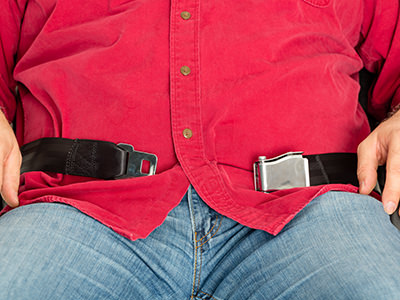 Troubles of flying while fat: obese passenger in a plane not being able to buckle his seatbelt, photo by oocoskun, Depositphotos