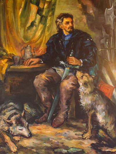 The painting of Erasmus of Lueg, or Erazem Predjamski, presented holding a sword while being seated in the company of two dogs, photo by Ivan Kralj.