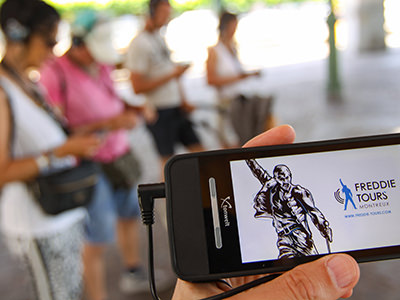 People at Freddie Tours in Montreux, Switzerland, following the interactive audio guide through the city late Queen frontman Freddie Mercury lived in, photo by Ivan Kralj.