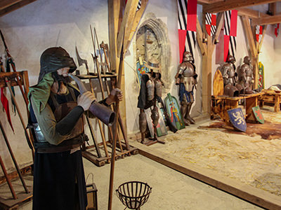 Knight armors and weapons displayed in Predjama Castle armory, Slovenia, photo by Ivan Kralj.