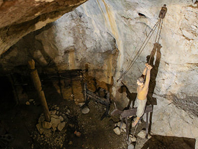 Dummy hanging on a rope above a horse, medieval torture device, in the supposed dungeon cave of Predjama Castle, Slovenia, photo by Ivan Kralj.