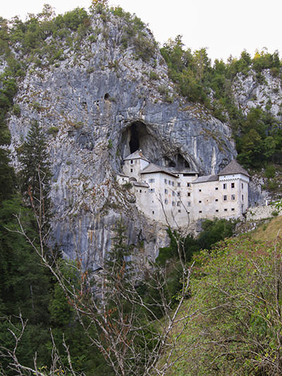 Exterior of the medieval Predjama Castle, the largest castle in the world built in the mouth of a cave, perched on 123-meter-high cliff in Predjama, Slovenia, photo by Ivan Kralj.