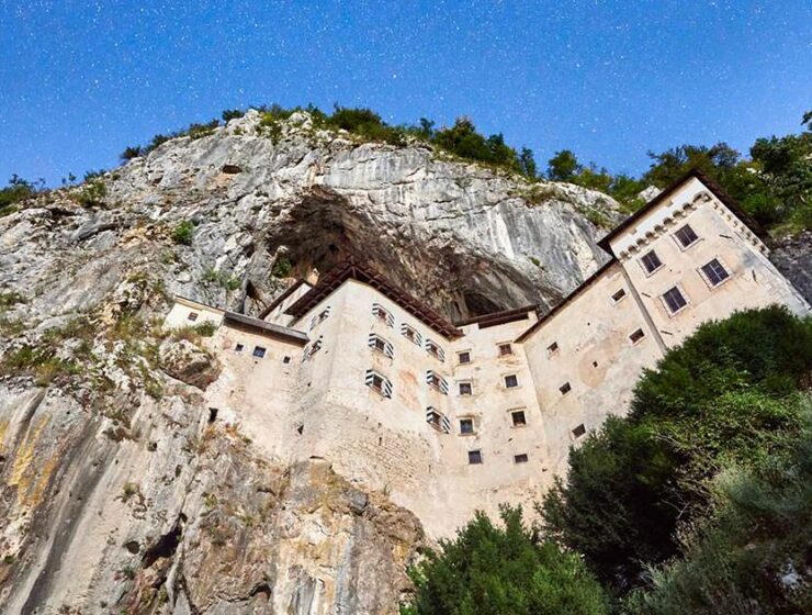 Predjama Castle exterior, embraced by the mountain, from a frog's-eye view, credit: Postojna Cave Park, Slovenia.