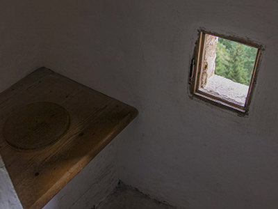 Old-school toilet with a little window seeing outside of Predjama Castle, Slovenia, photo by Ivan Kralj.