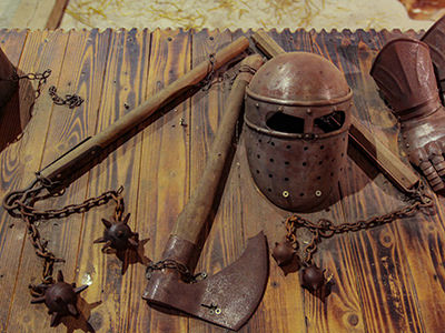 Knight helmet and weapons such as ax and flail, as displayed in Predjama Castle armory, photo by Ivan Kralj.