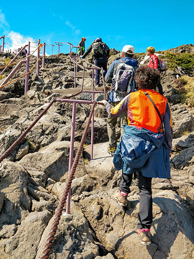 Hikers ascending Hallasan Mountain over rocks, the final part of the hiking trail to the highest summit of South Korea, photo by Ivan Kralj.