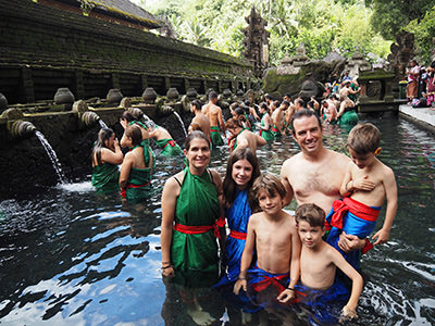 Edith Lemay, Sebastien Pelletier and their four children in Pura Tirta Empul, water temple in Bali, during their world voyage on a quest for visual memories before three of their children lose their eyesight, photo credit Edith Lemay