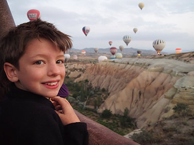Leo, one of the four children of Edith Lemay and Sebastien Pelletier, observing the hot-air balloons in Cappadocia, Turkey, on the family's trip around the world, photo by Edith Lemay