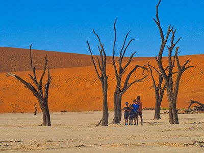 Four Canadian children posing in the Namibian desert on their world trip, photo by Edith Lemay
