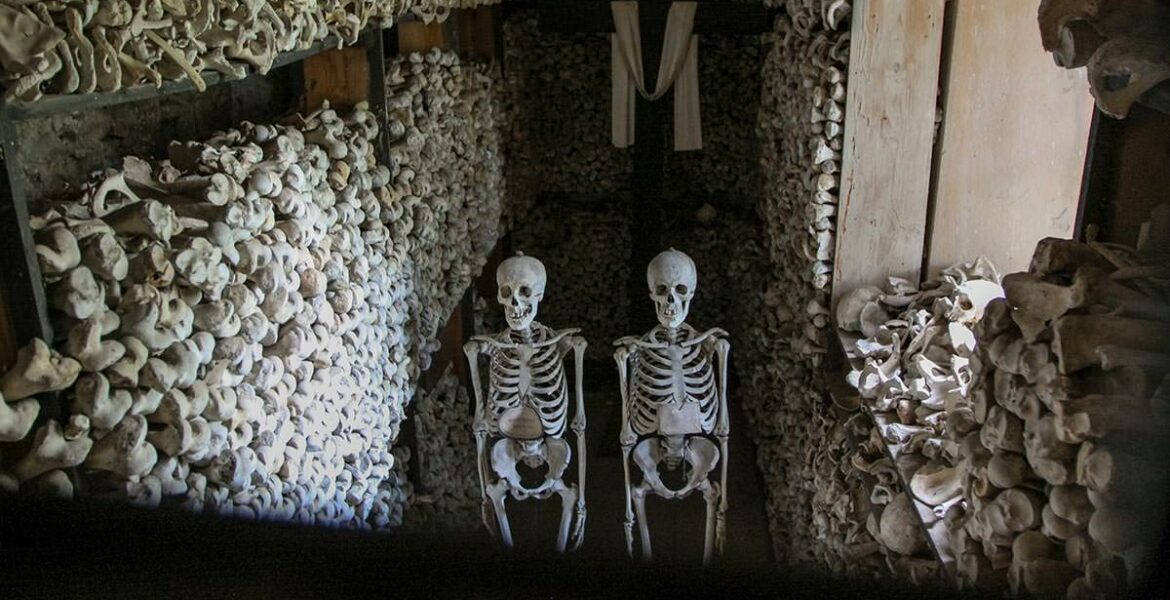 Chamber with skeletons, bones and a cross in Ossuary of Solferino, Lombardy, Italy, photo by Ivan Kralj