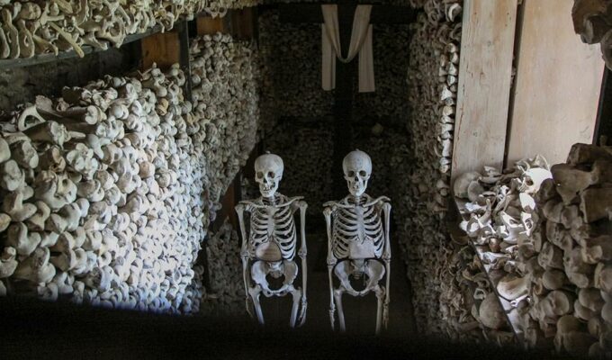 Chamber with skeletons, bones and a cross in Ossuary of Solferino, Lombardy, Italy, photo by Ivan Kralj