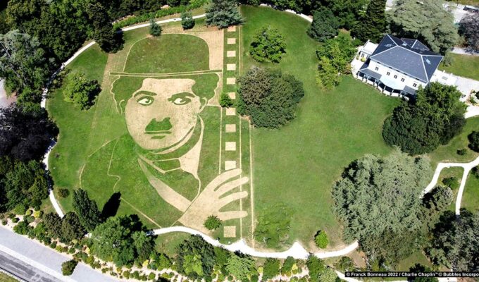 Aerial photograph of Charlie Chaplin's Little Tramp portrait in land art form on a meadow of the silent movie legend's estate in Corsier-sur-Vevey, Switzerland, by artist Franck Bonneau