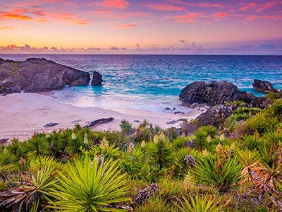 Sandy Bermuda beach under a colorful sunset, photo by Mark Harpur, Unsplash.