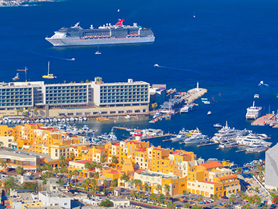 Cruise ship near coastal town, photo by Alex Hugessen, Unsplash.