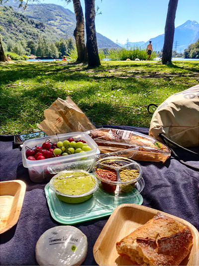 Grapes, bread, spreads and cheese on the picnic blanket by the lake, Domaine des Iles, Switzerland, photo by Ivan Kralj.