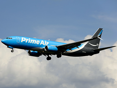 Amazon Prime Air cargo plane Boeing 737-86N above the clouds, photo by Forsaken Films, Unsplash.